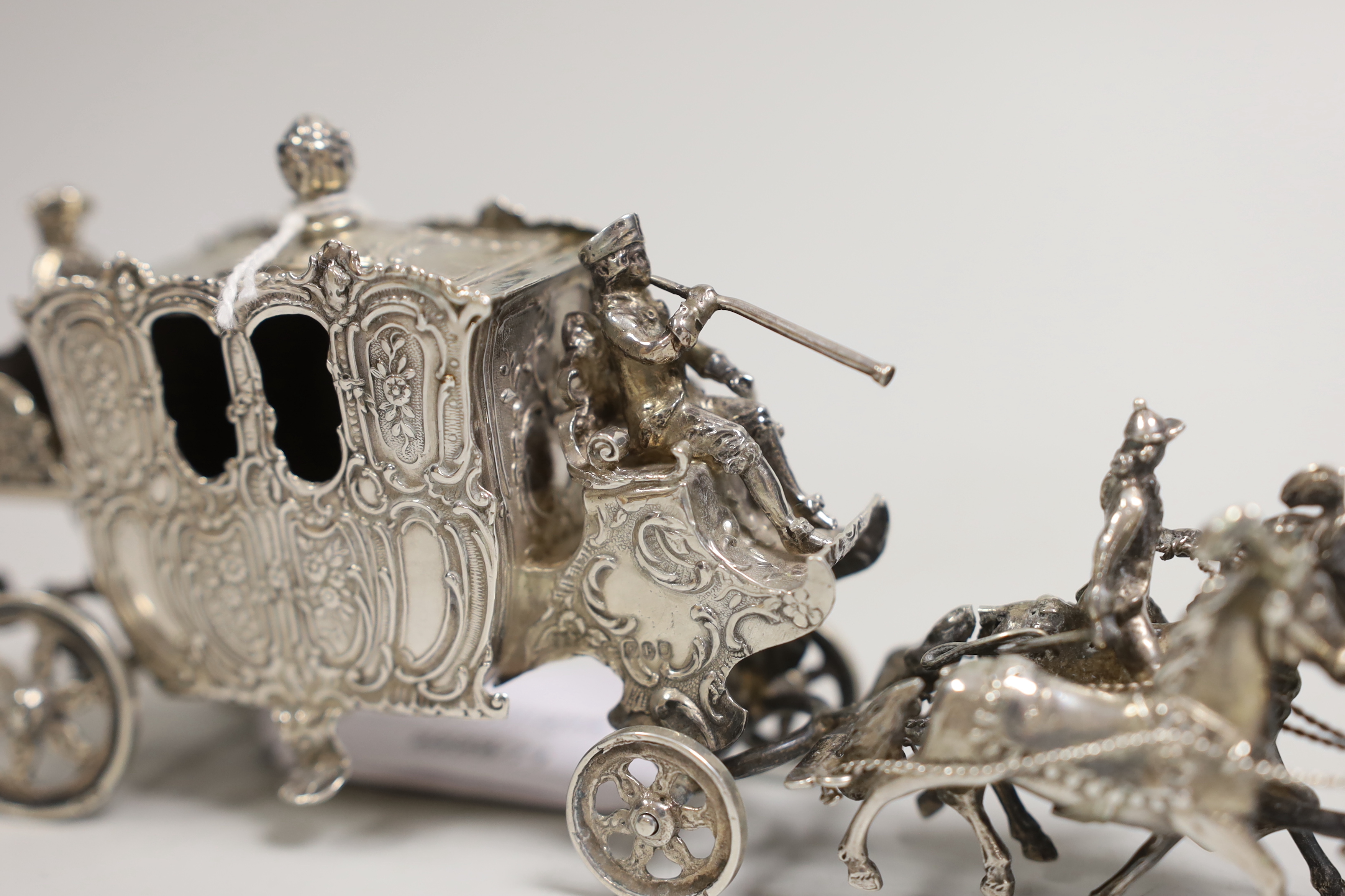 An Edwardian Hanau silver model of a coaching procession, import marks for London, 1901, length 24cm, 10.9oz.